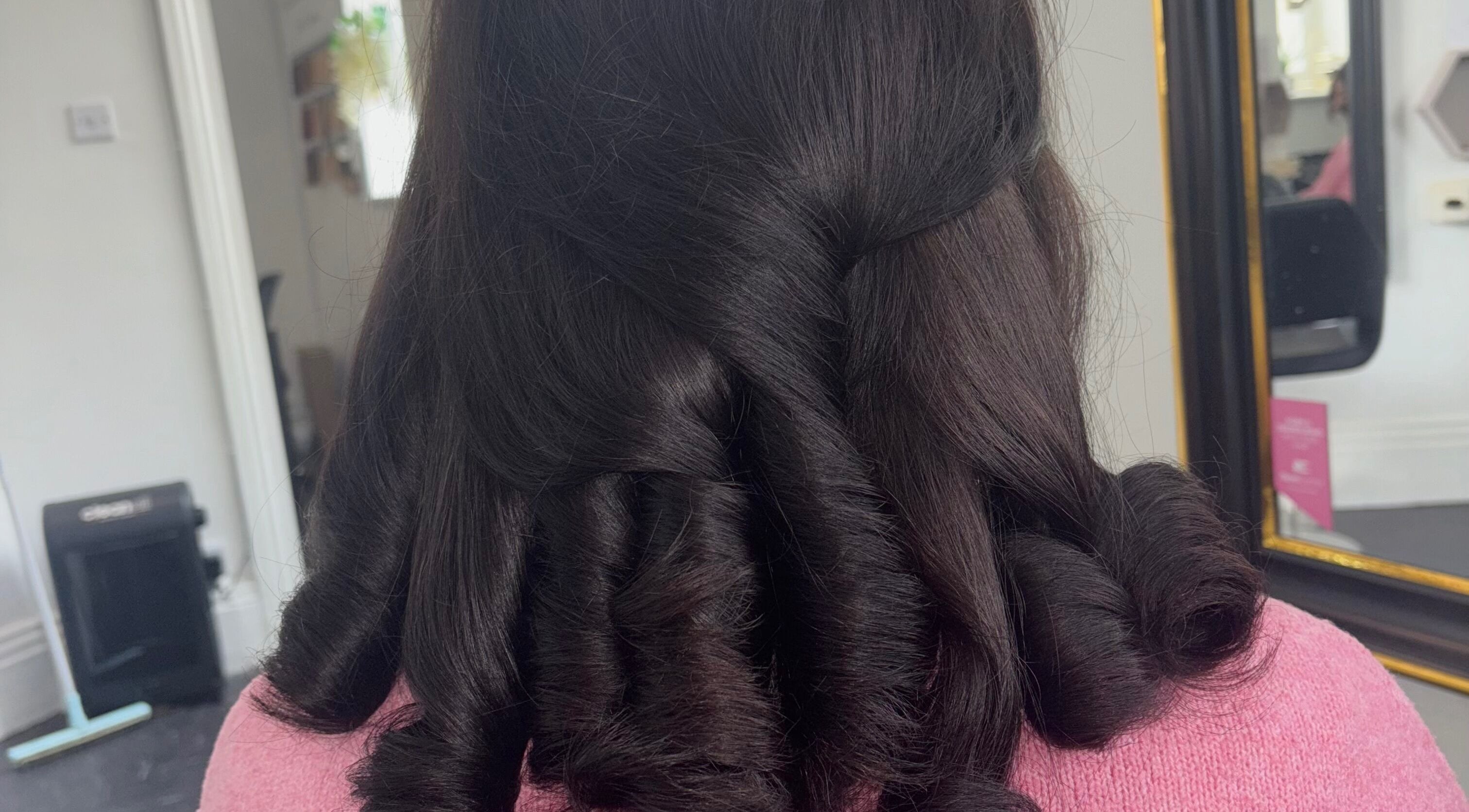 Styled curls at Hair by Lottie, Weston-super-Mare, England, GB in a sleek salon environment.