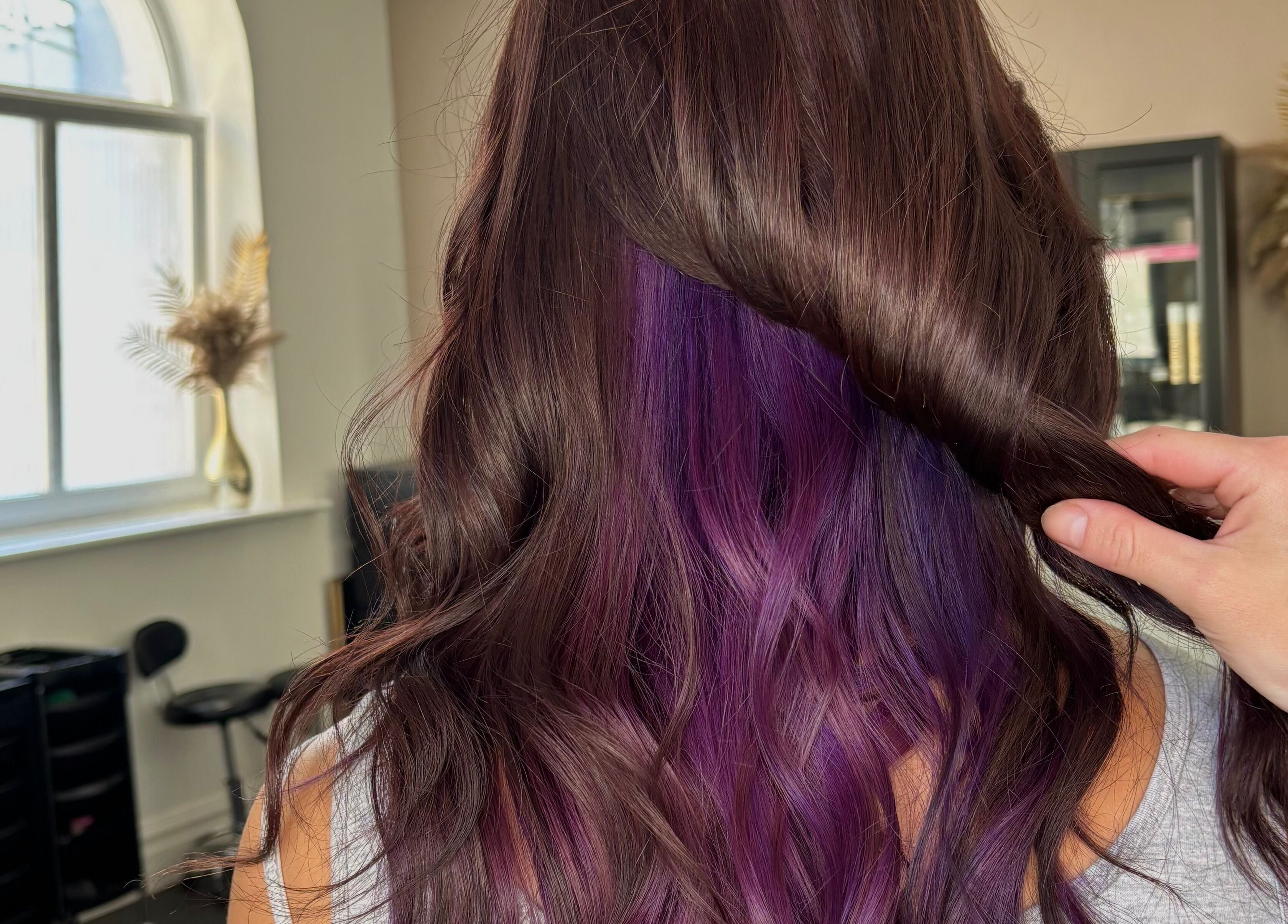 Vibrant purple hair under silky brown curls at Hair by Lottie, Weston-super-Mare, England, GB.