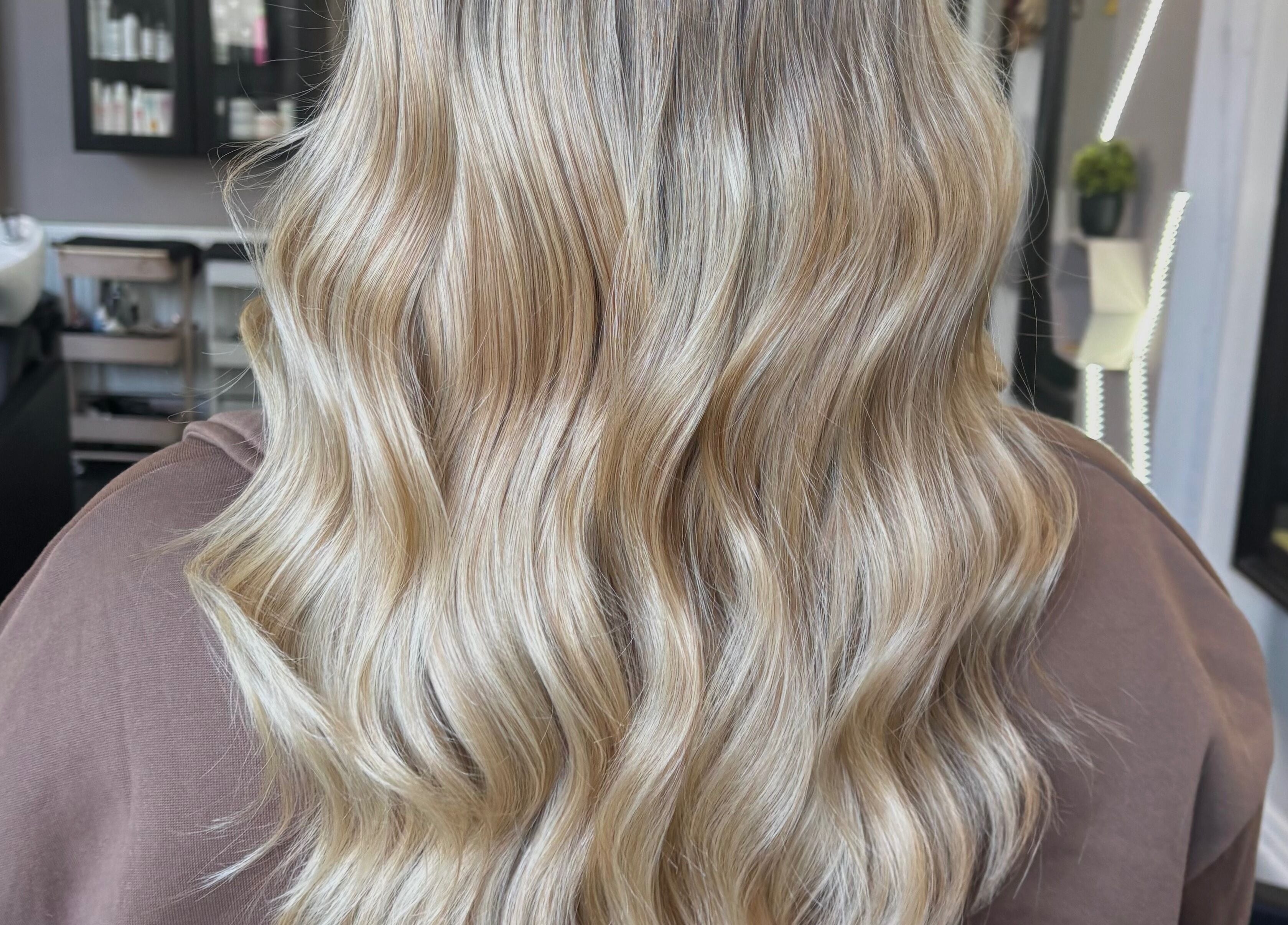 Blonde wavy hair styled at Hair by Lottie, Weston-super-mare, England, GB, in a chic salon setting.