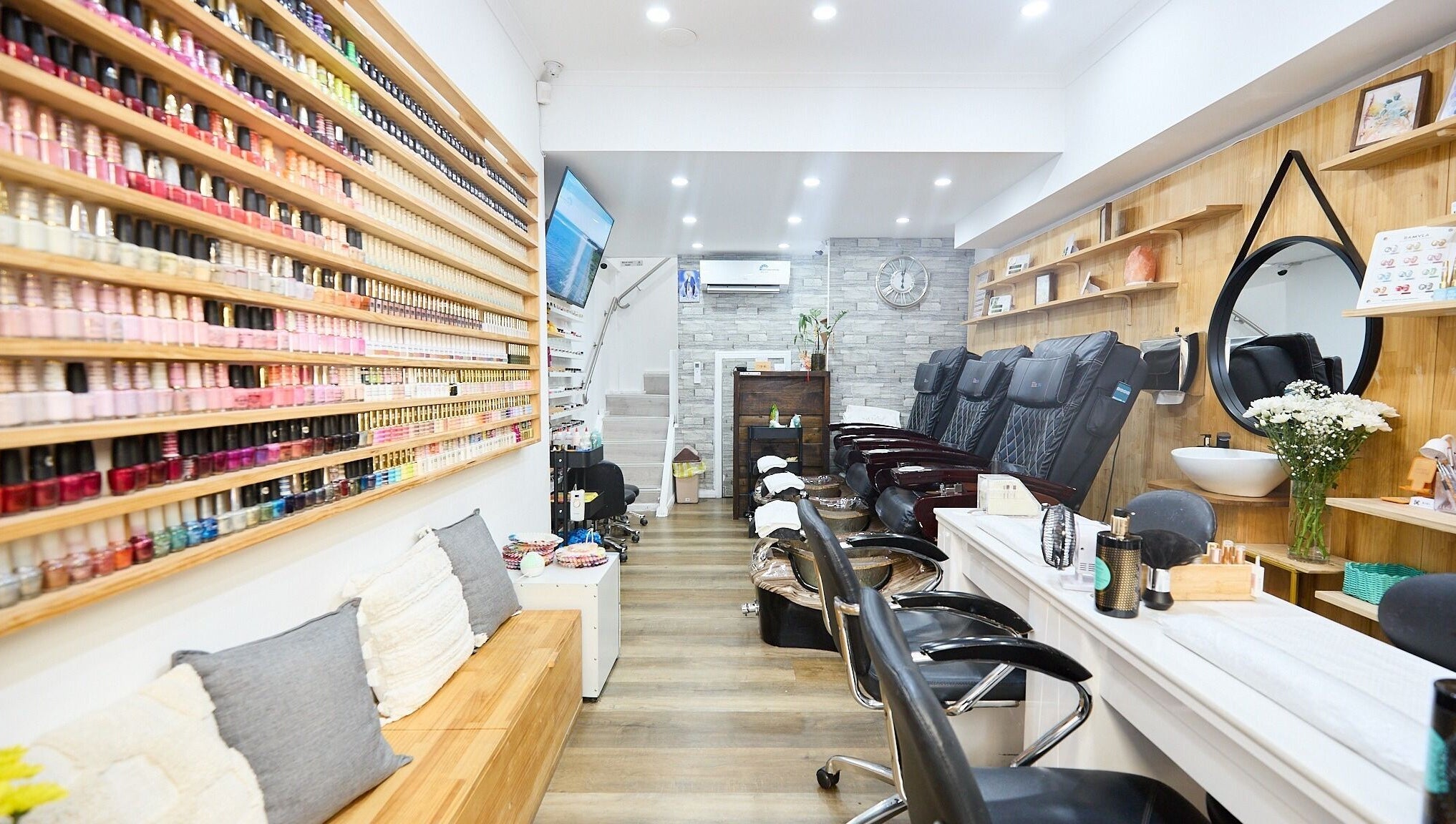 Interior of MIA Nails & Beauties in Darlinghurst, NSW, AU showcasing stylish nail polish display and seating.
