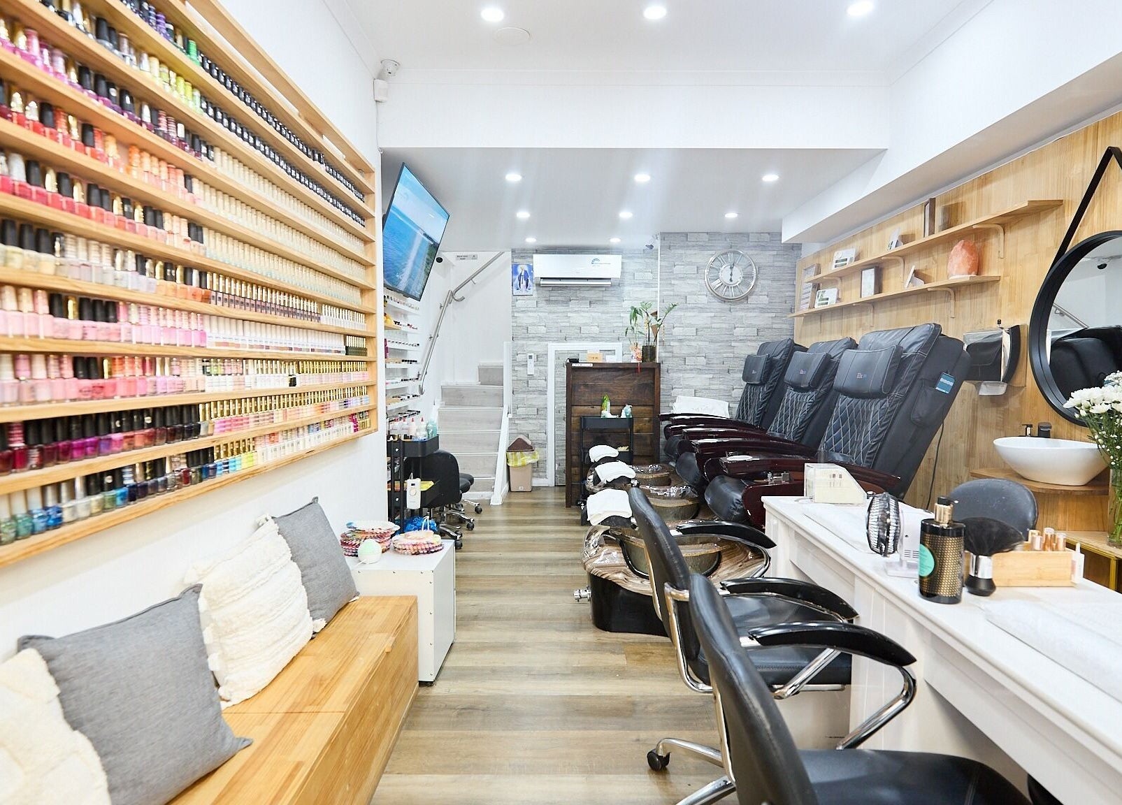Interior of MIA Nails & Beauties in Darlinghurst, NSW, AU showcasing stylish nail polish display and seating.