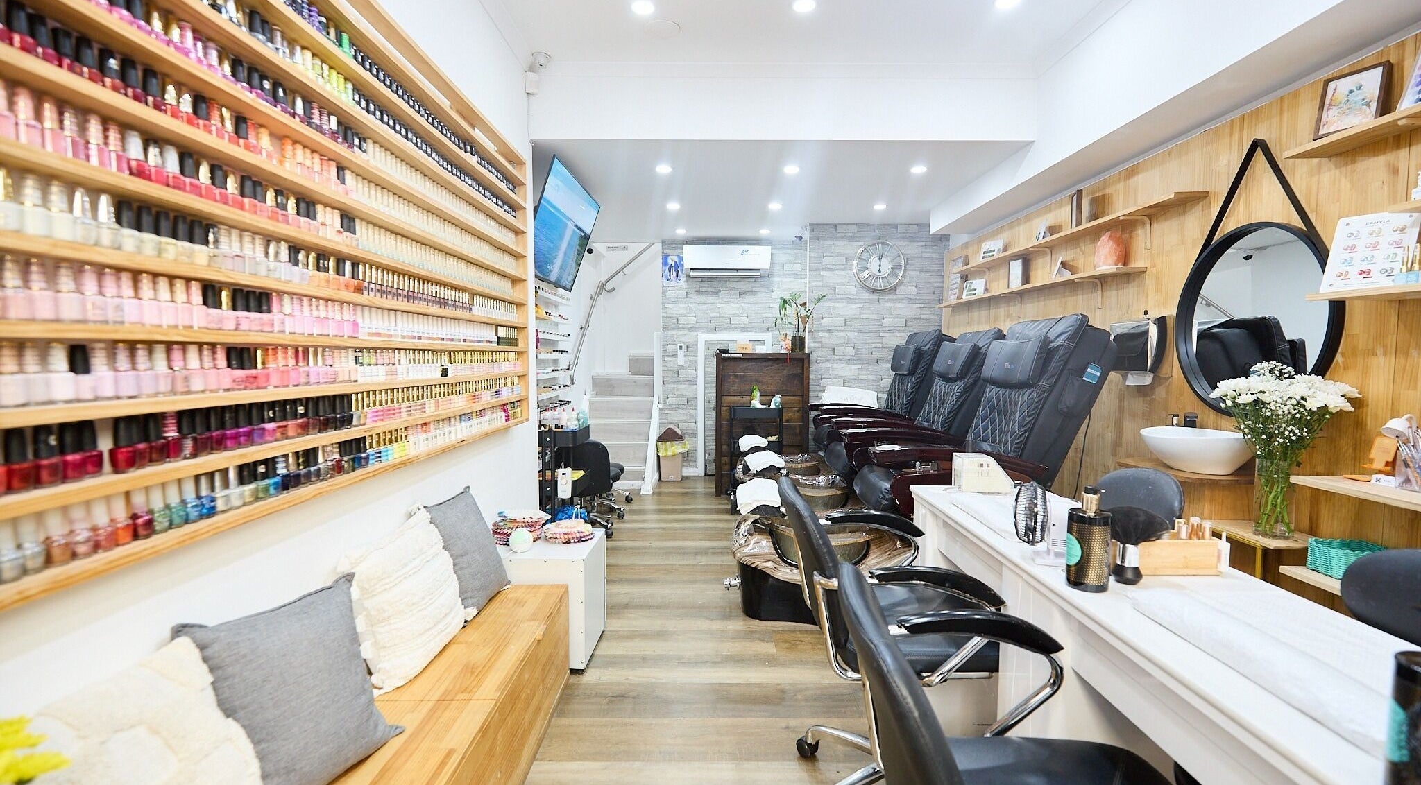 Interior of MIA Nails & Beauties in Darlinghurst, NSW, AU showcasing stylish nail polish display and seating.