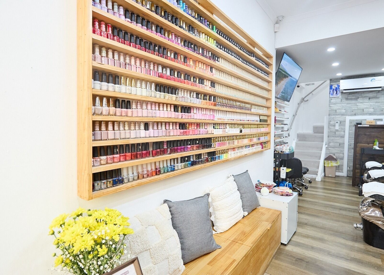 Interior of MIA Nails & Beauties, Darlinghurst, NSW, AU with a vibrant wall of nail polishes.