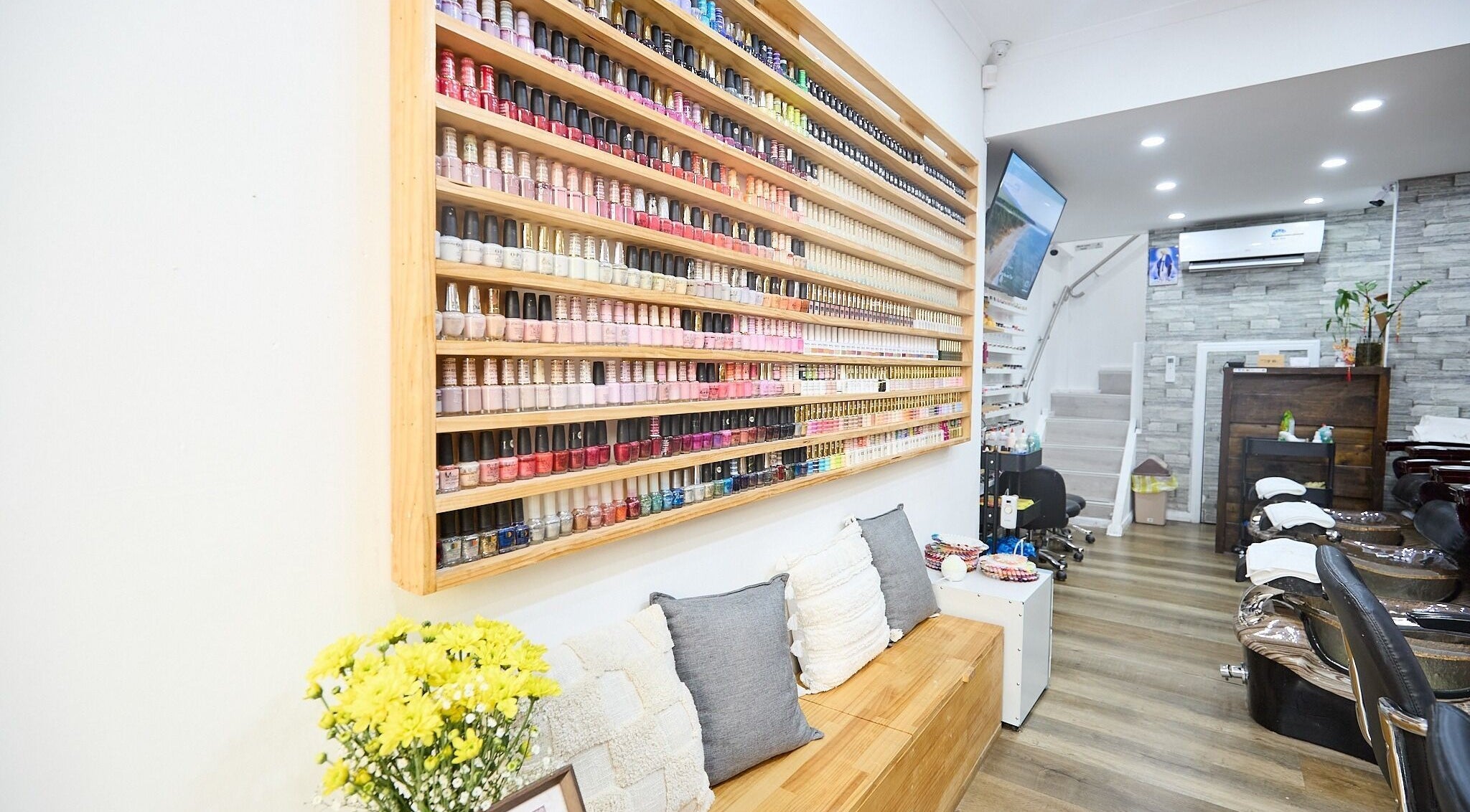Interior of MIA Nails & Beauties, Darlinghurst, NSW, AU with a vibrant wall of nail polishes.