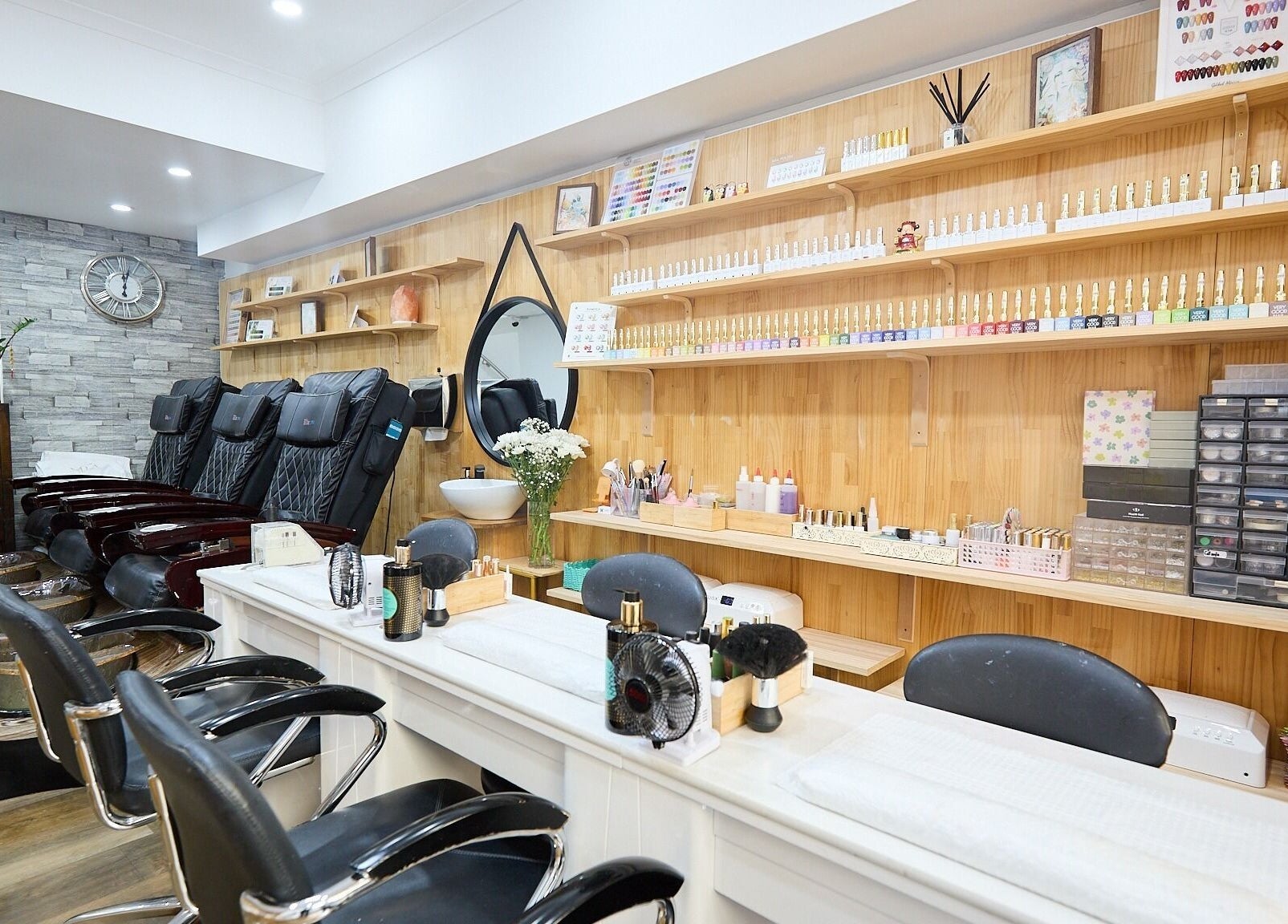 Tranquil interior of MIA Nails & Beauties, Darlinghurst, NSW, AU, featuring plush chairs and nail polishes.