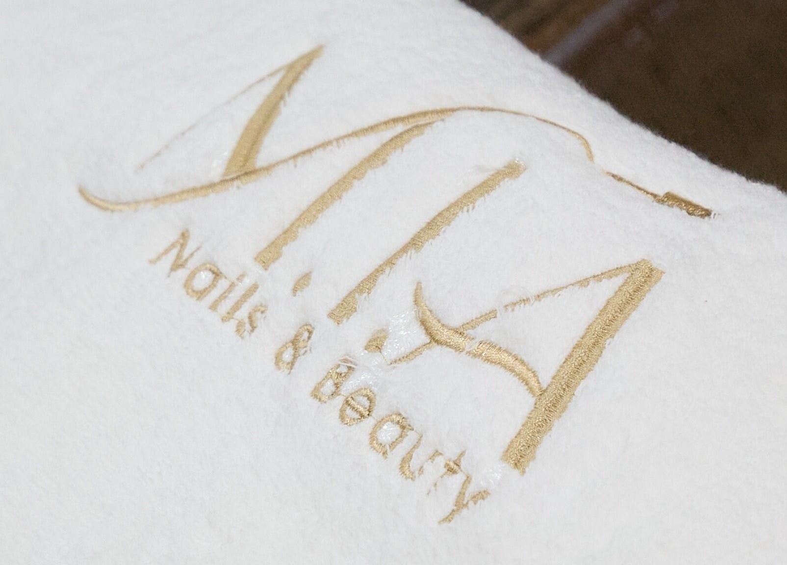 MIA Nails & Beauties logo on plush fabric at Darlinghurst, NSW, AU, highlighting luxury and elegance.