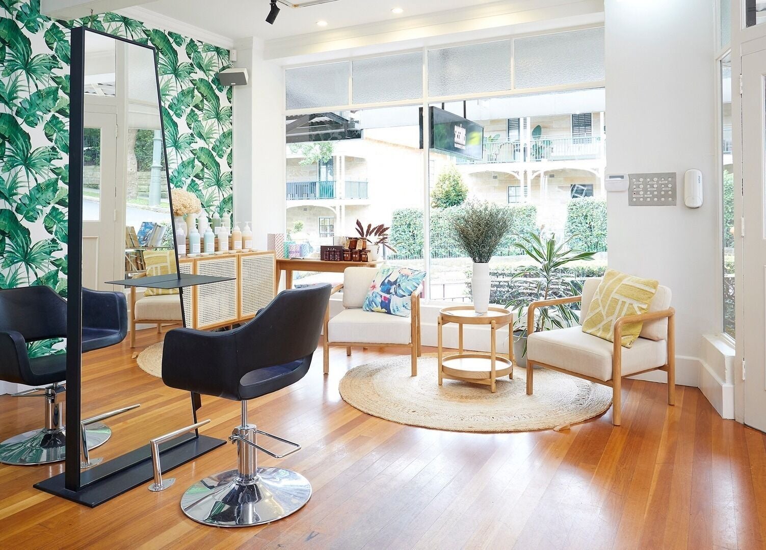Chic interior of Sessions Hairdressing, Mcmahons Point, New South Wales, AU with lush decor and modern seating.