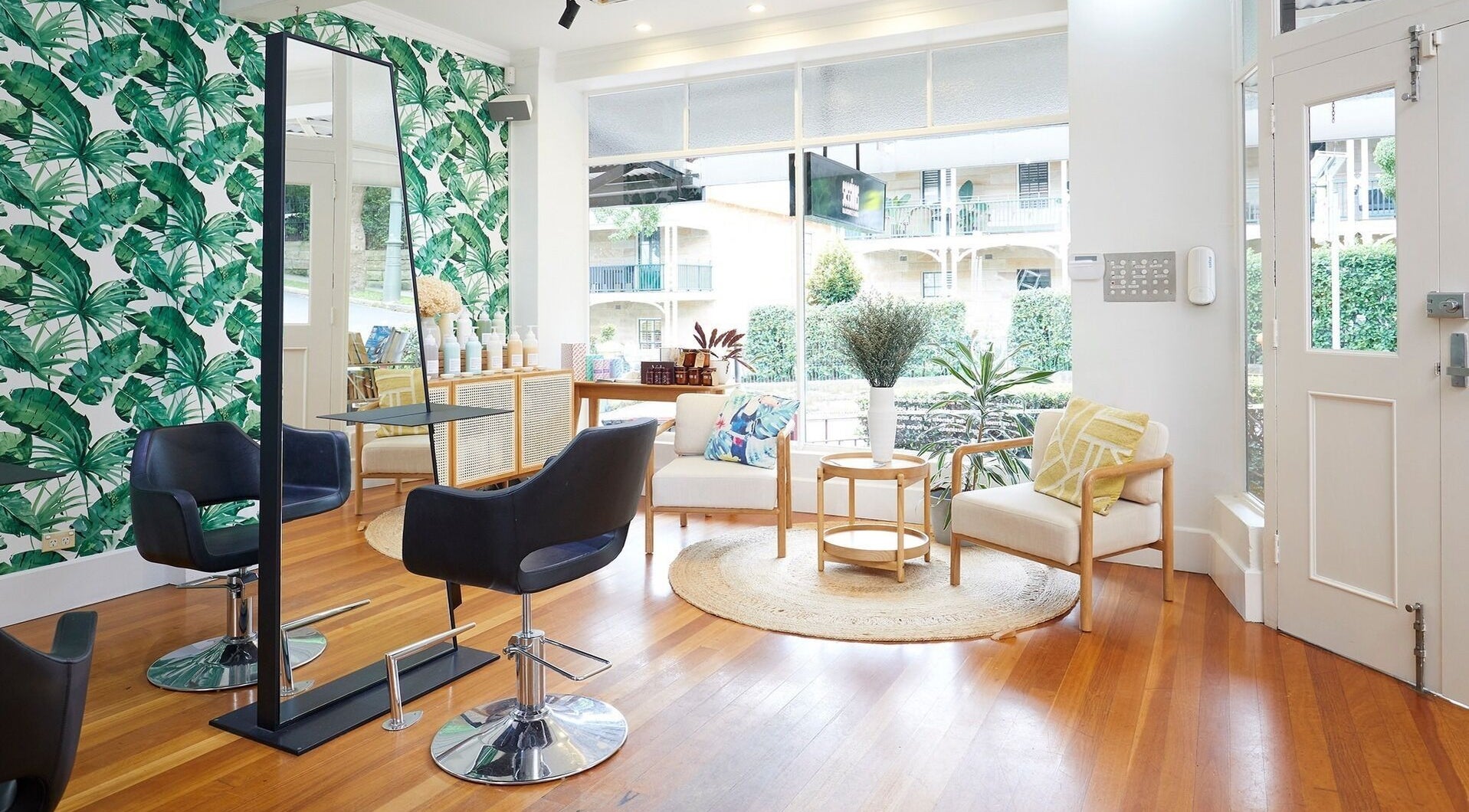 Chic interior of Sessions Hairdressing, Mcmahons Point, New South Wales, AU with lush decor and modern seating.