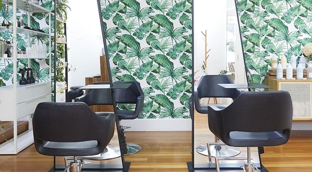 Chic hair salon with tropical decor at Sessions Hairdressing in Mcmahons Point, New South Wales, AU.