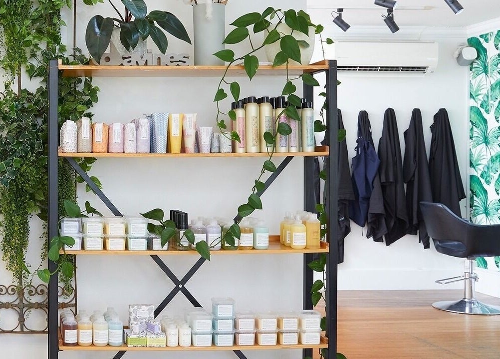 Stylish hair salon interior at Sessions Hairdressing, Mcmahons Point, New South Wales, AU with lush greenery.