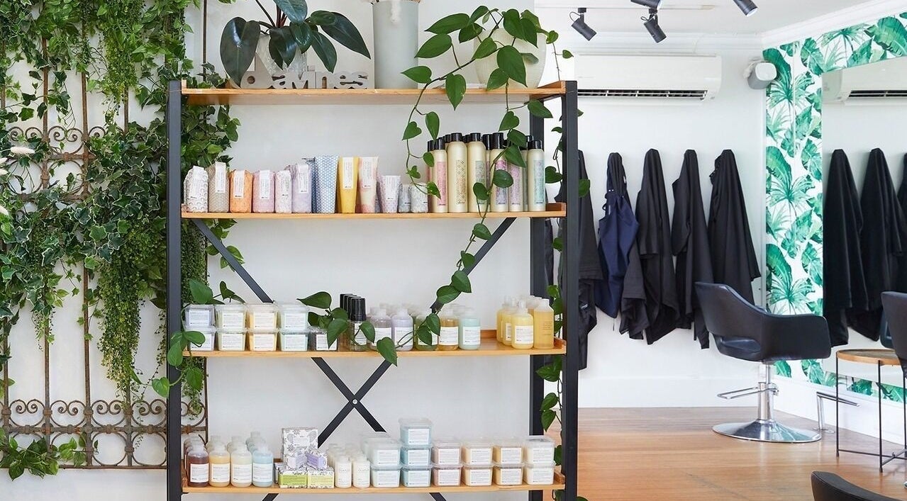 Stylish hair salon interior at Sessions Hairdressing, Mcmahons Point, New South Wales, AU with lush greenery.