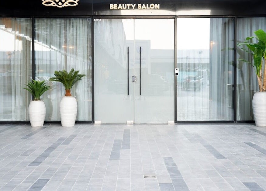 Yoush Spa entrance with glass doors and potted plants in Riyadh, Riyadh Province, SA.