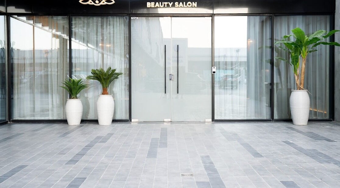 Yoush Spa entrance with glass doors and potted plants in Riyadh, Riyadh Province, SA.