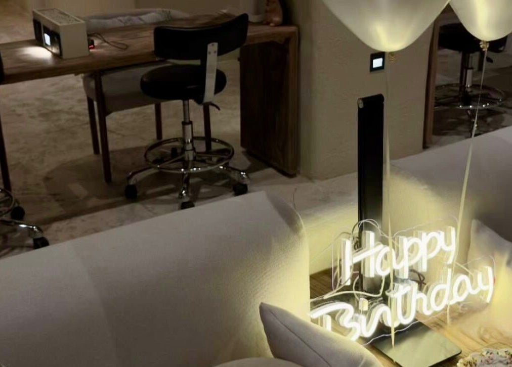 Yoush Spa in Riyadh features a cozy nook with a 'Happy Birthday' neon sign and luxurious seating.
