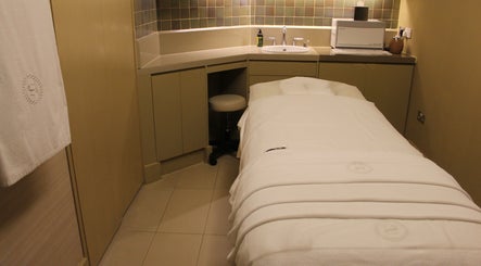 Relaxing massage room at Namm Spa, Dubai, Dubai, AE, showcasing a treatment bed with cozy linens.