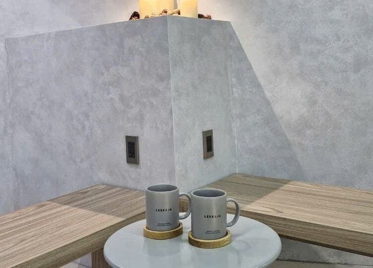 Two branded mugs on wooden surface at LEEKAJA Diamond Plaza, Hồ Chí Minh, Hồ Chí Minh, VN.