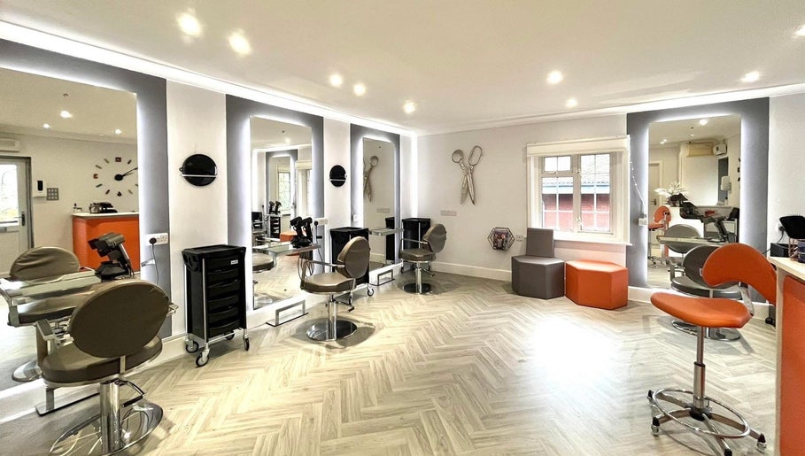Modern salon interior at Hair by Ellie in Sidmouth, England, GB with stylish chairs and lighting.