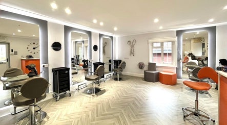 Modern salon interior at Hair by Ellie in Sidmouth, England, GB with stylish chairs and lighting.
