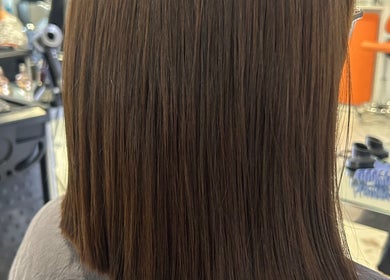 Sleek haircut at Hair by Ellie, Sidmouth, England, GB. Modern styling showing glossy, straight brown hair.