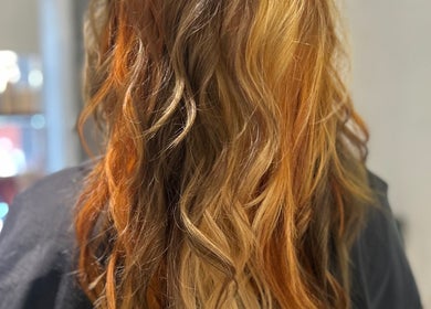 Vibrant, wavy brown and blonde hair at Hair by Ellie in Sidmouth, England, GB.