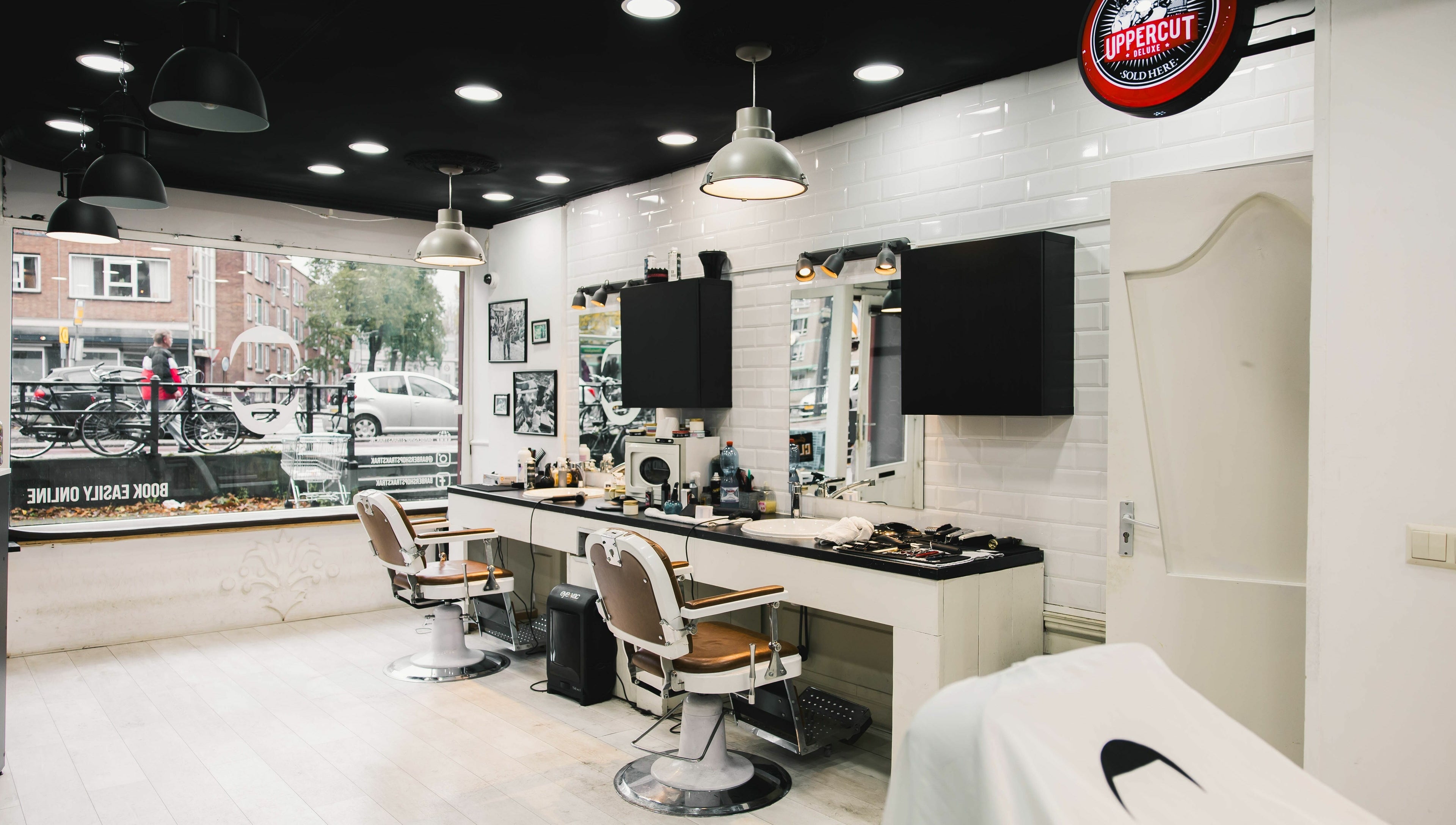 Modern interior of Strak Strak - Barbershop in Rotterdam, South Holland, NL, with stylish chairs and decor.