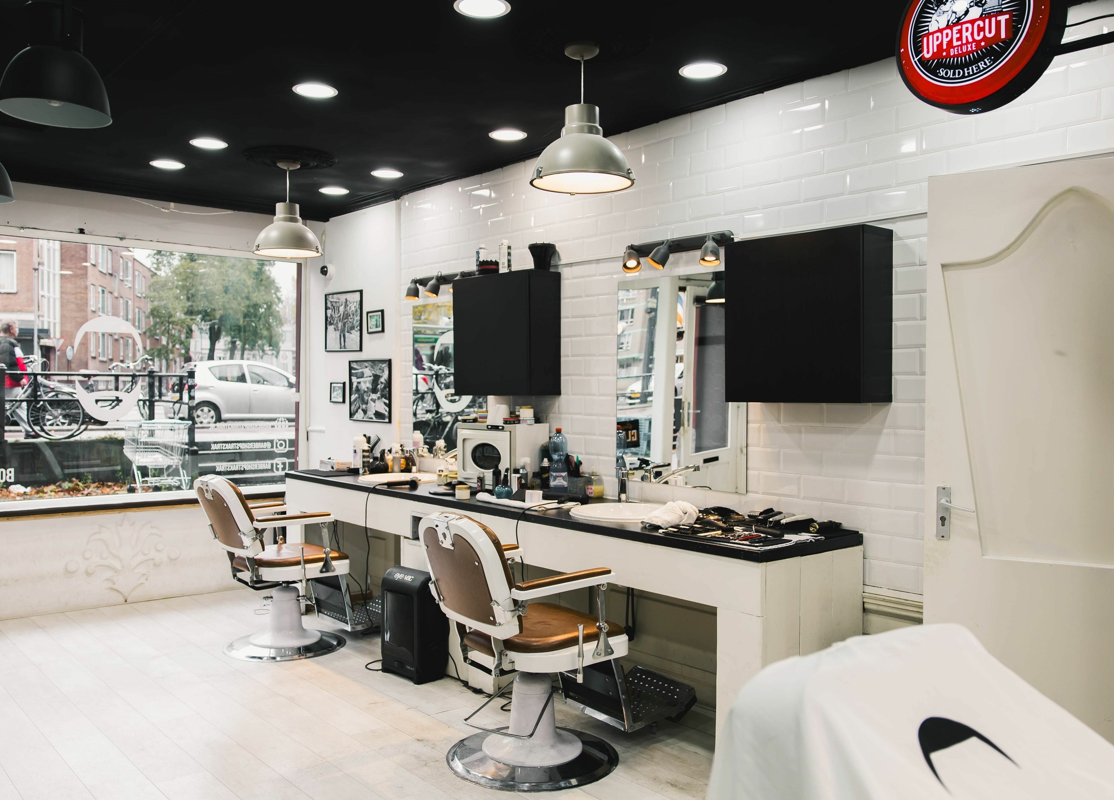 Modern interior of Strak Strak - Barbershop in Rotterdam, South Holland, NL, with stylish chairs and decor.