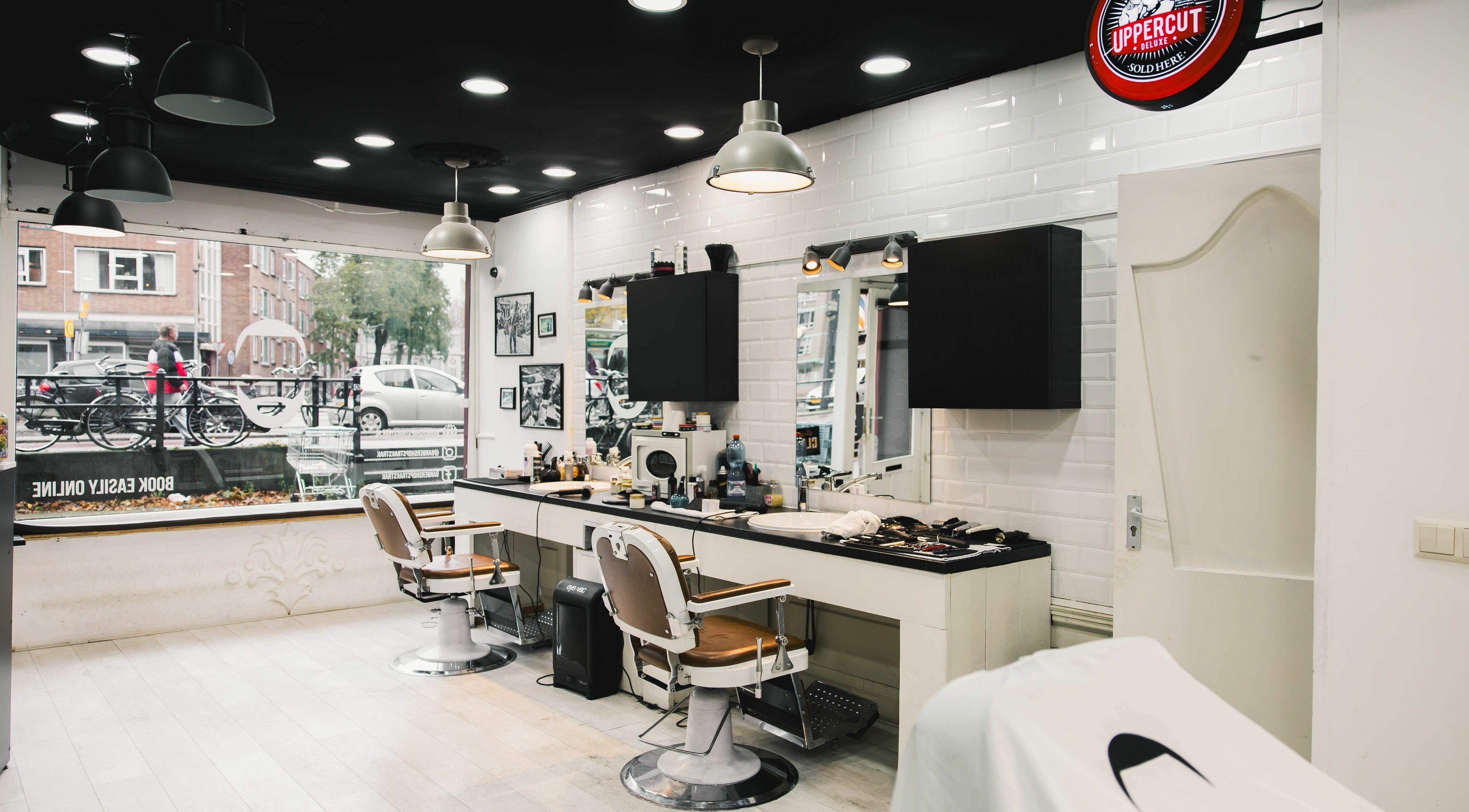 Modern interior of Strak Strak - Barbershop in Rotterdam, South Holland, NL, with stylish chairs and decor.