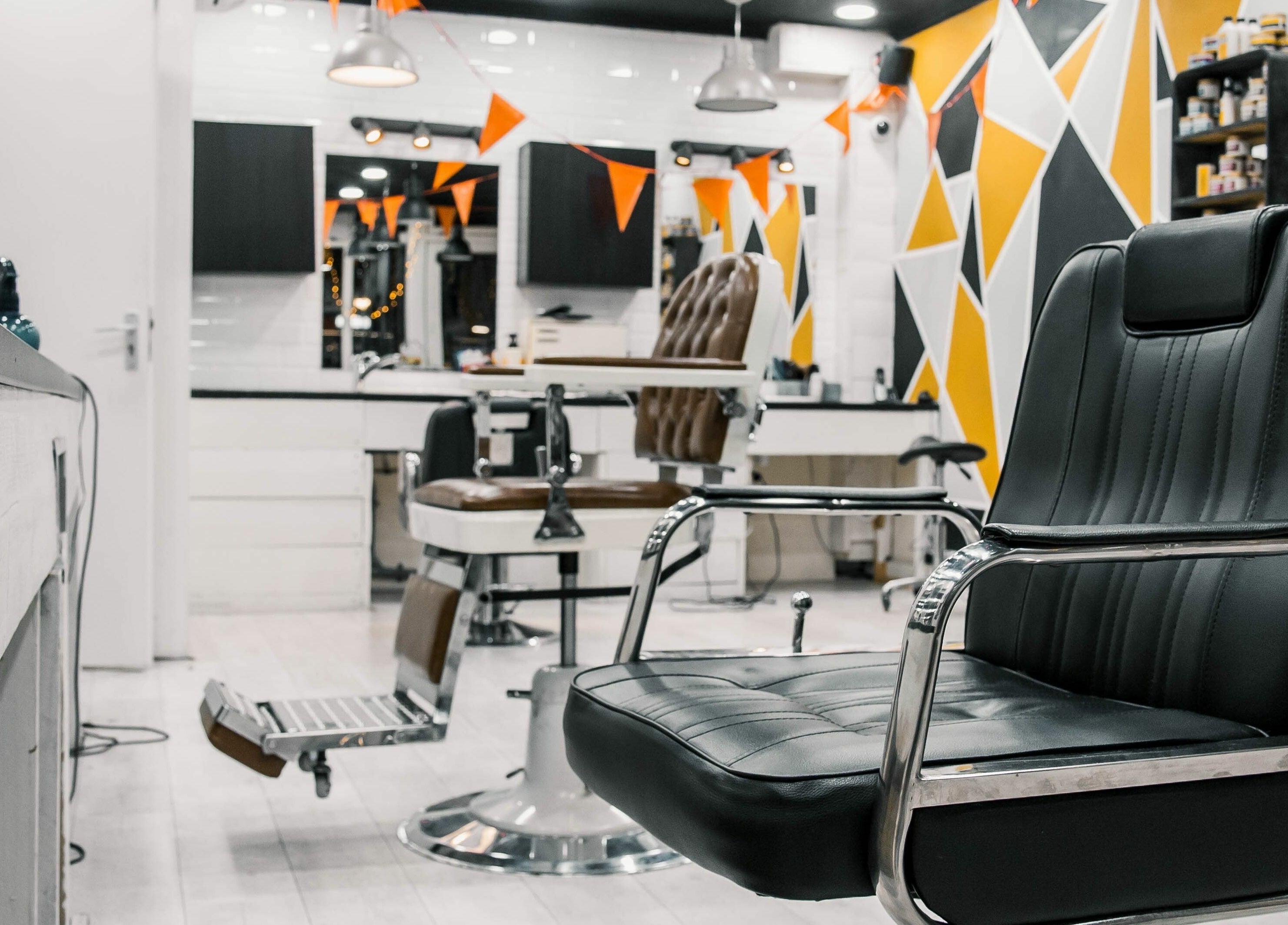Interior of Strak Strak - Barbershop, Rotterdam, South Holland, NL showcasing modern chairs and vibrant decor.