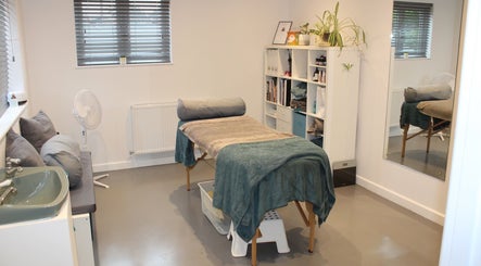 Peaceful treatment room at Valkyrie Performance and Aesthetics, Norwich, England, GB, with cozy massage table.