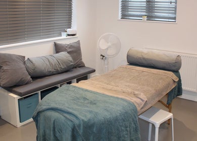 Calm treatment room at Valkyrie Performance and Aesthetics in Norwich, England, GB, featuring a cozy massage bed.