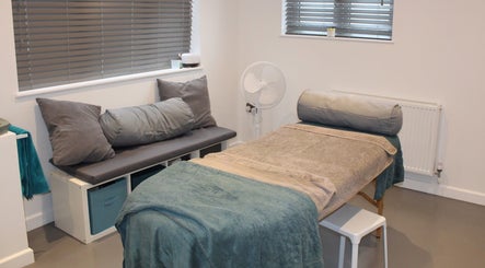 Calm treatment room at Valkyrie Performance and Aesthetics in Norwich, England, GB, featuring a cozy massage bed.