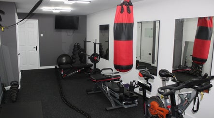 Modern gym setup at Valkyrie Performance and Aesthetics, Norwich, England, GB with cycling and boxing equipment.