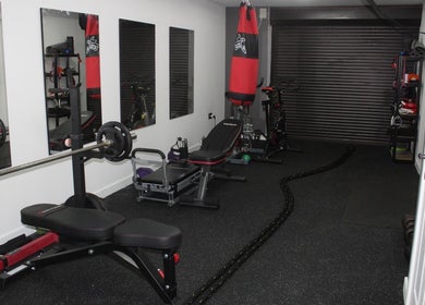 Well-equipped gym at Valkyrie Performance and Aesthetics, Norwich, England, GB, featuring weights and mirrors.