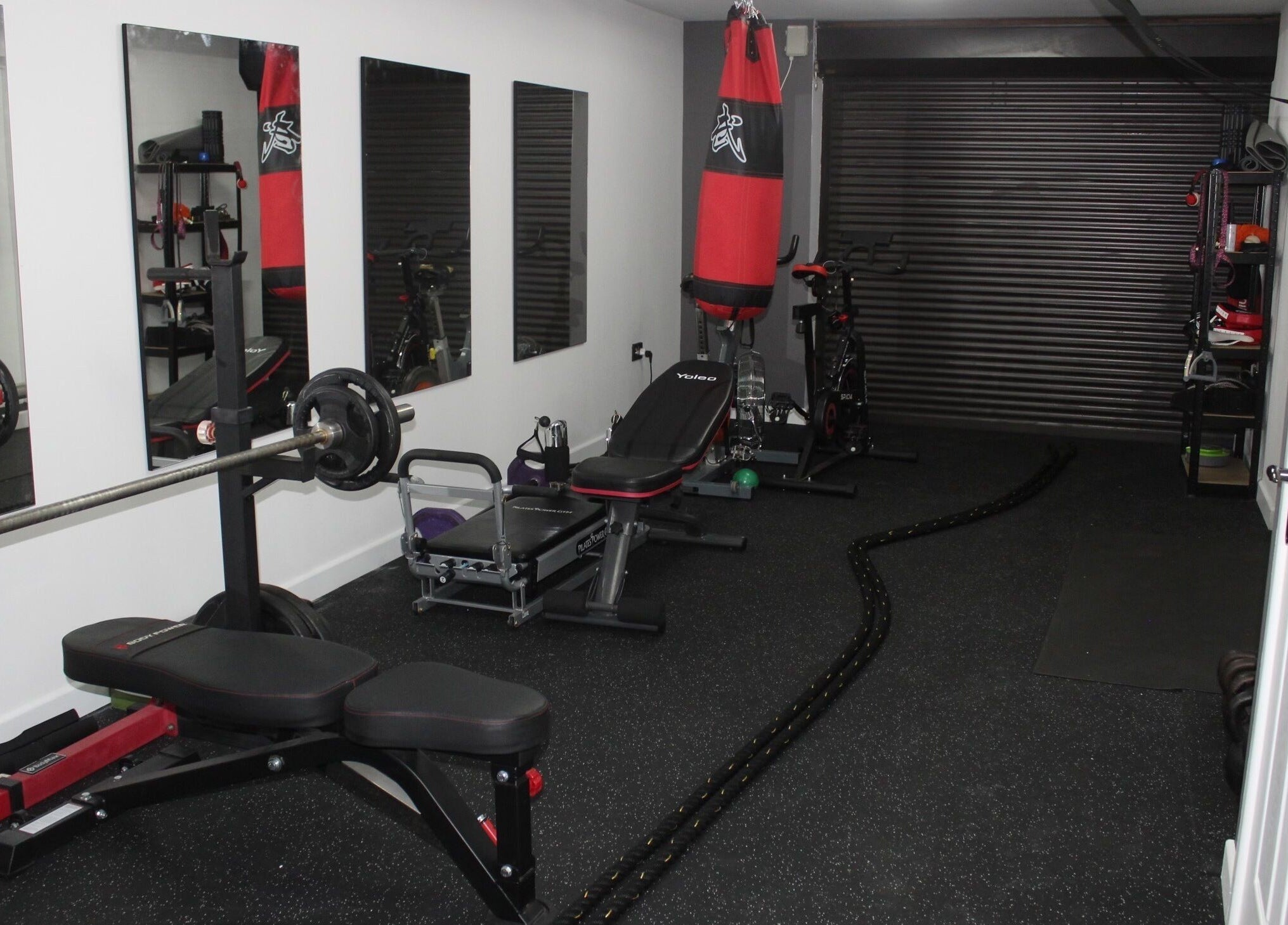 Well-equipped gym at Valkyrie Performance and Aesthetics, Norwich, England, GB, featuring weights and mirrors.
