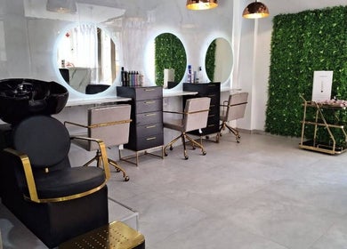 Stylish salon interior at The Glam Lounge, Berea, Kwazulu-natal, ZA with modern decor and sleek styling stations.