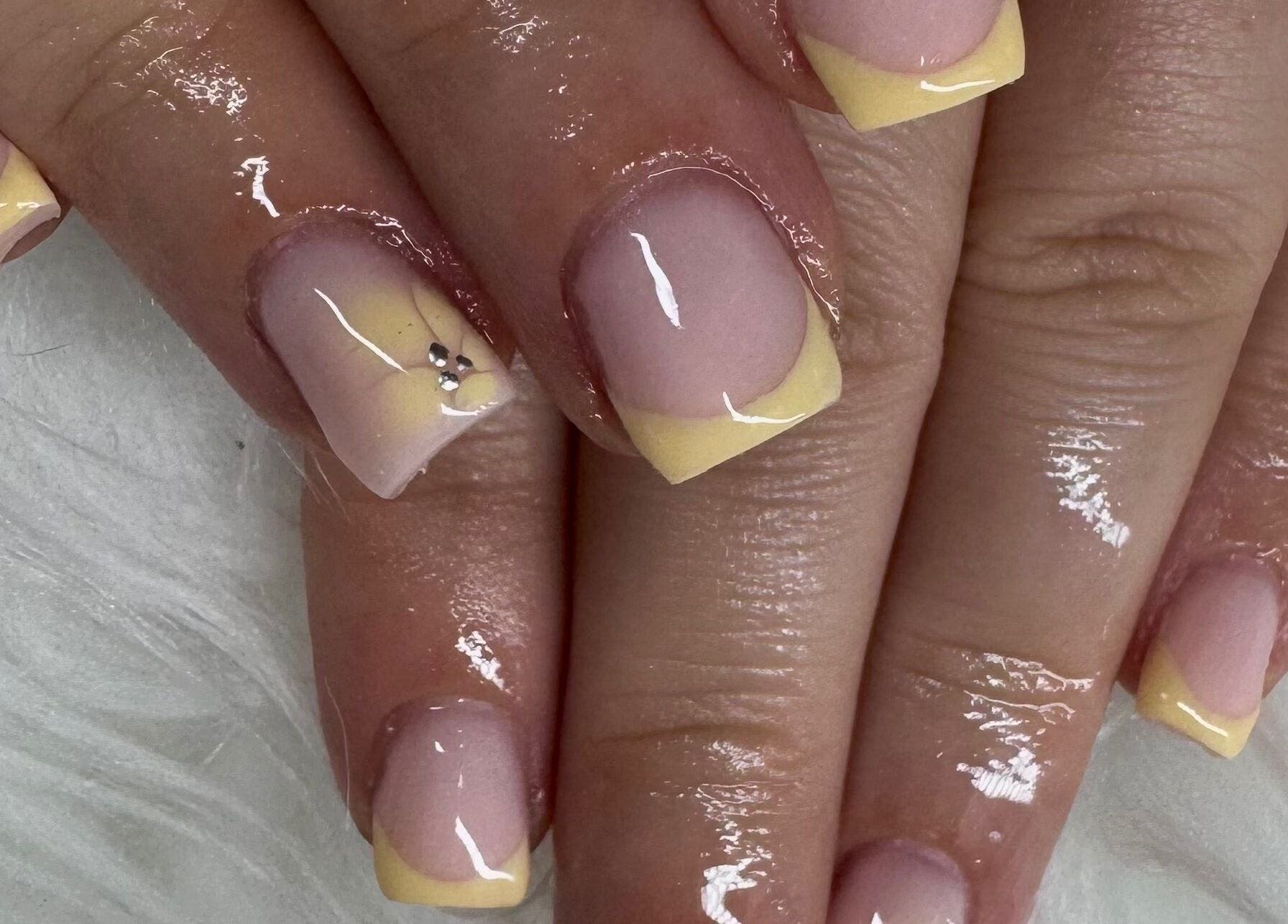 Pastel yellow manicure with gems at Nailsbysoph Xox, Ruthin, Wales, GB.
