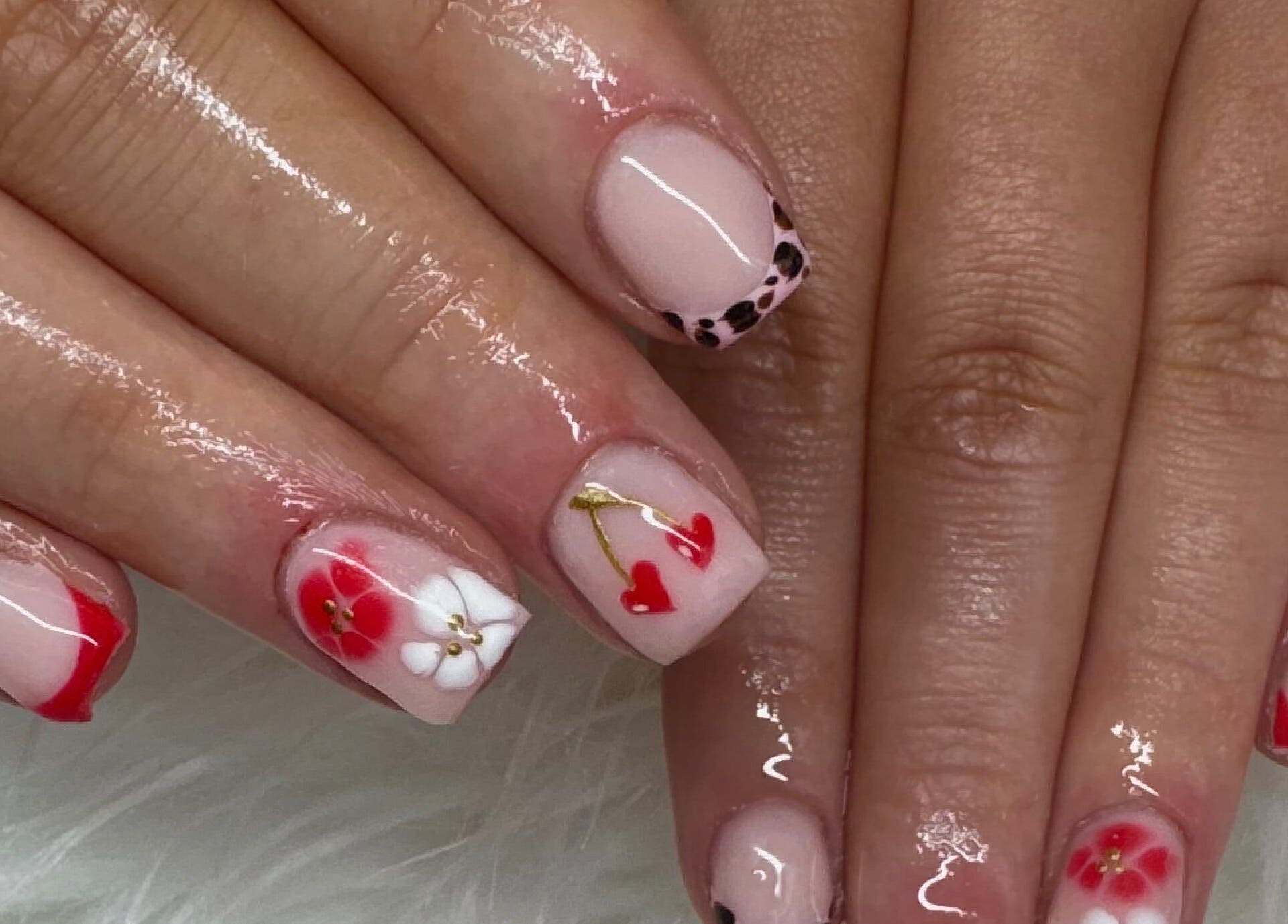 Creative nail art at Nailsbysoph Xox, Ruthin, Wales, GB featuring red, white, and black designs.