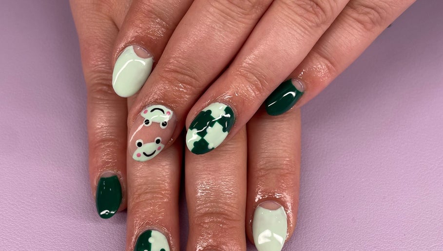 Playful frog nail art at Nails by Ames, Pullman, Washington, US. Unique design with green and white polish.