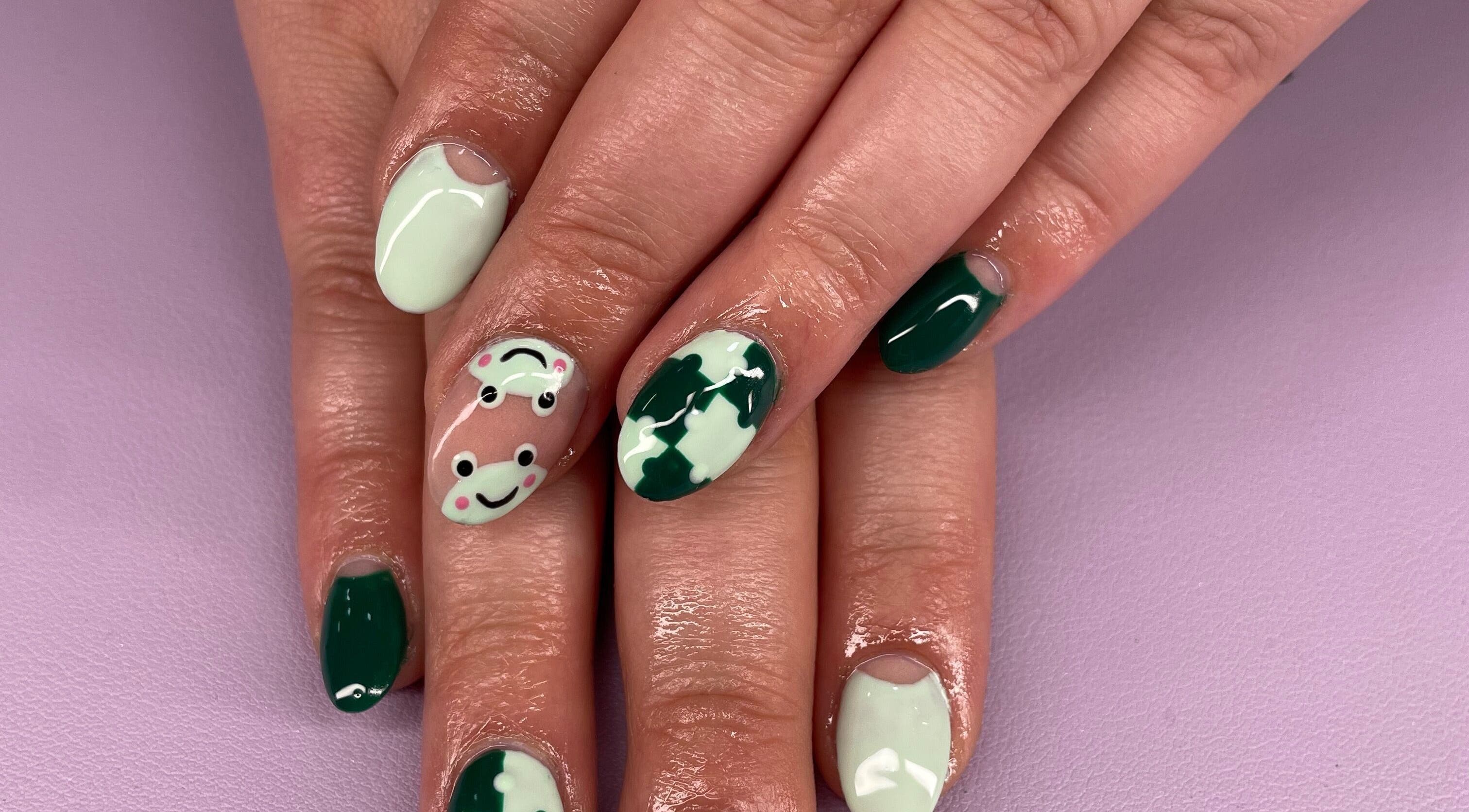 Playful frog nail art at Nails by Ames, Pullman, Washington, US. Unique design with green and white polish.