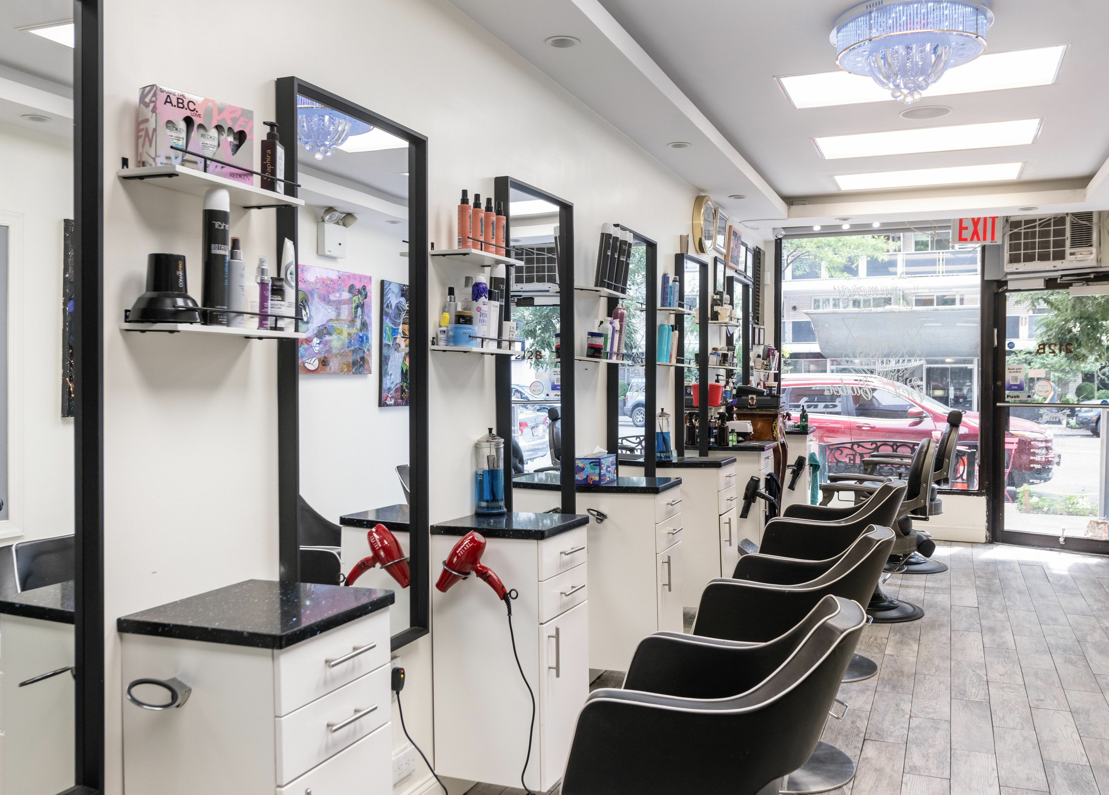 Modern salon interior at Balayage Studio, New York, New York, US, featuring sleek styling chairs and bright decor.