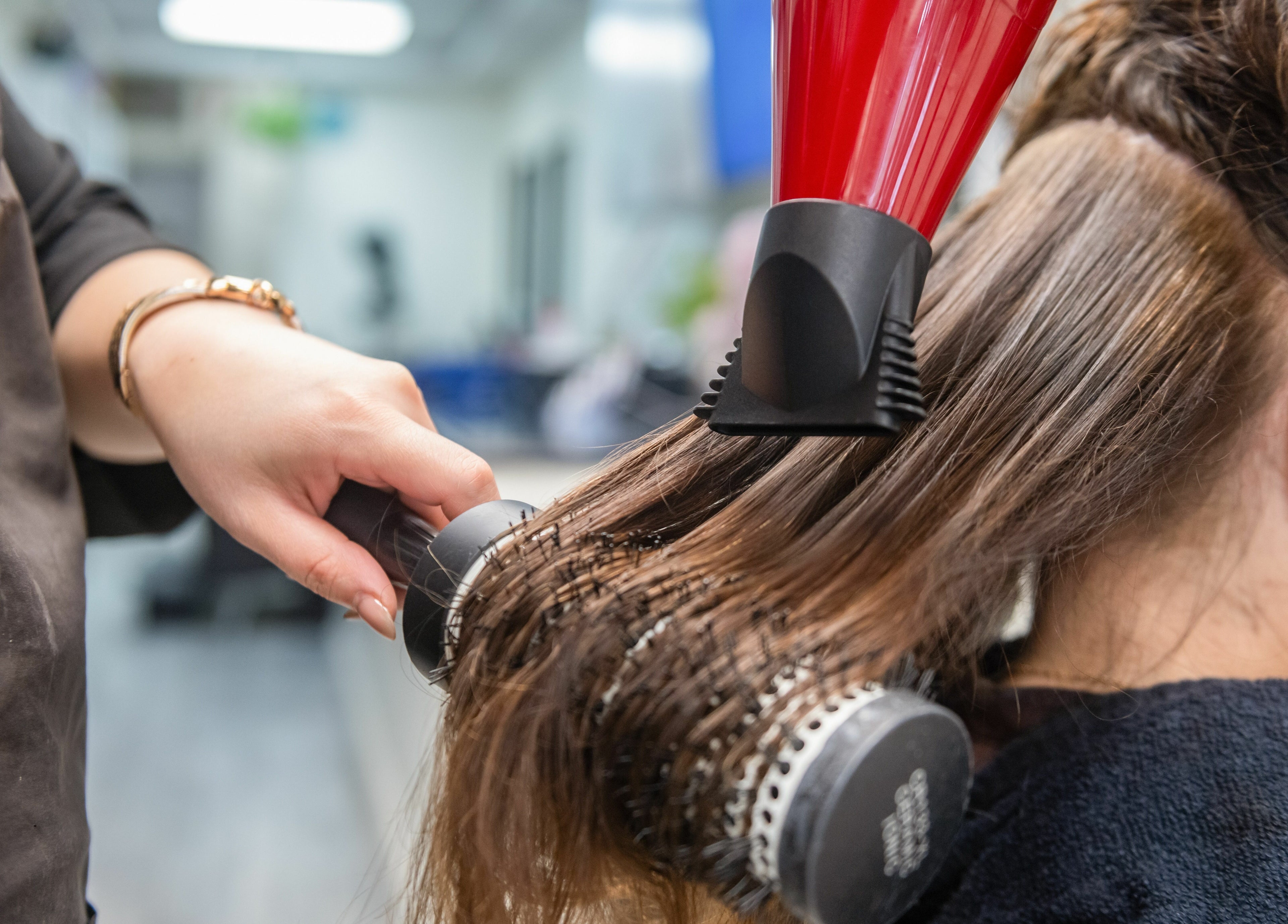 Expert hair styling at Balayage Studio, New York, New York, US, showcasing professional blow-dry technique.