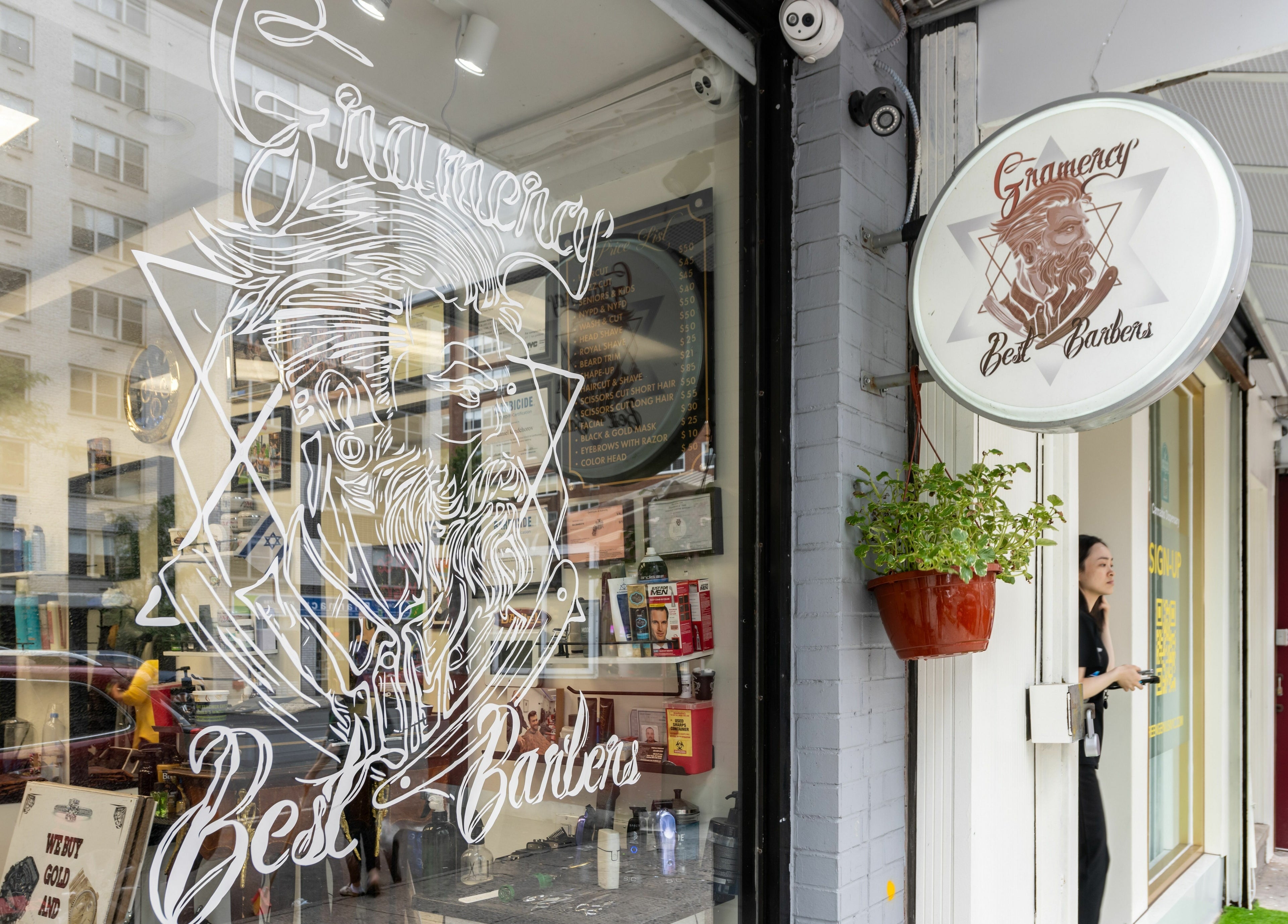 Entrance of Balayage Studio barbershop in New York, New York, US with artistic window design.