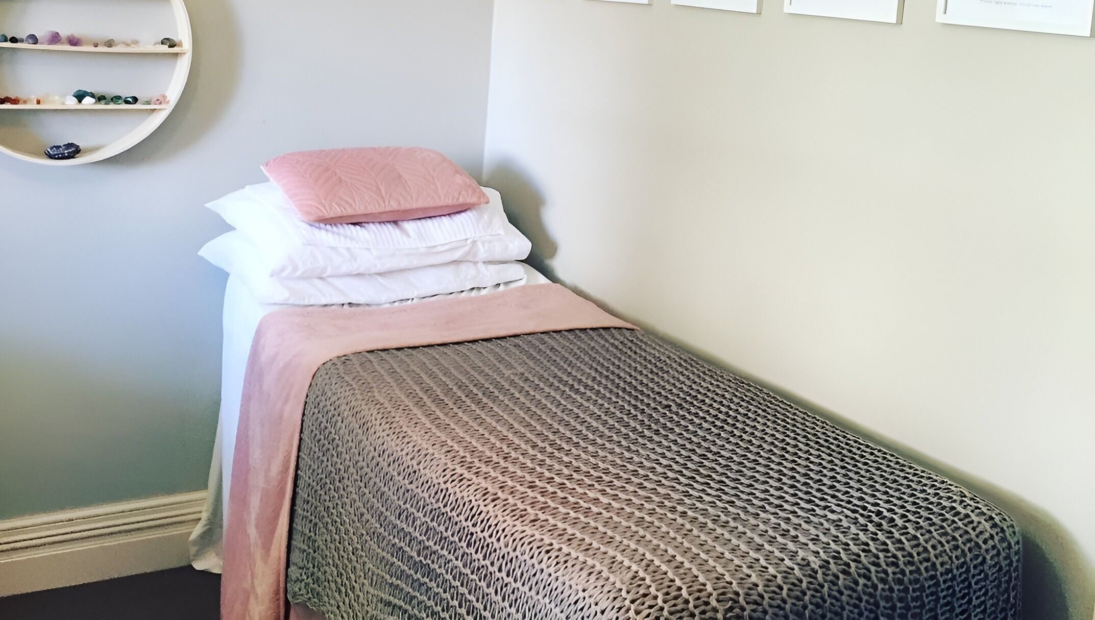 Relaxing treatment room at Kylie Paekau, Hamilton, Waikato, NZ featuring a cozy bed with soft pink accents.