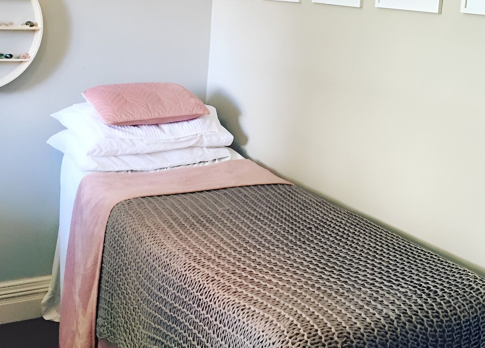Relaxing treatment room at Kylie Paekau, Hamilton, Waikato, NZ featuring a cozy bed with soft pink accents.