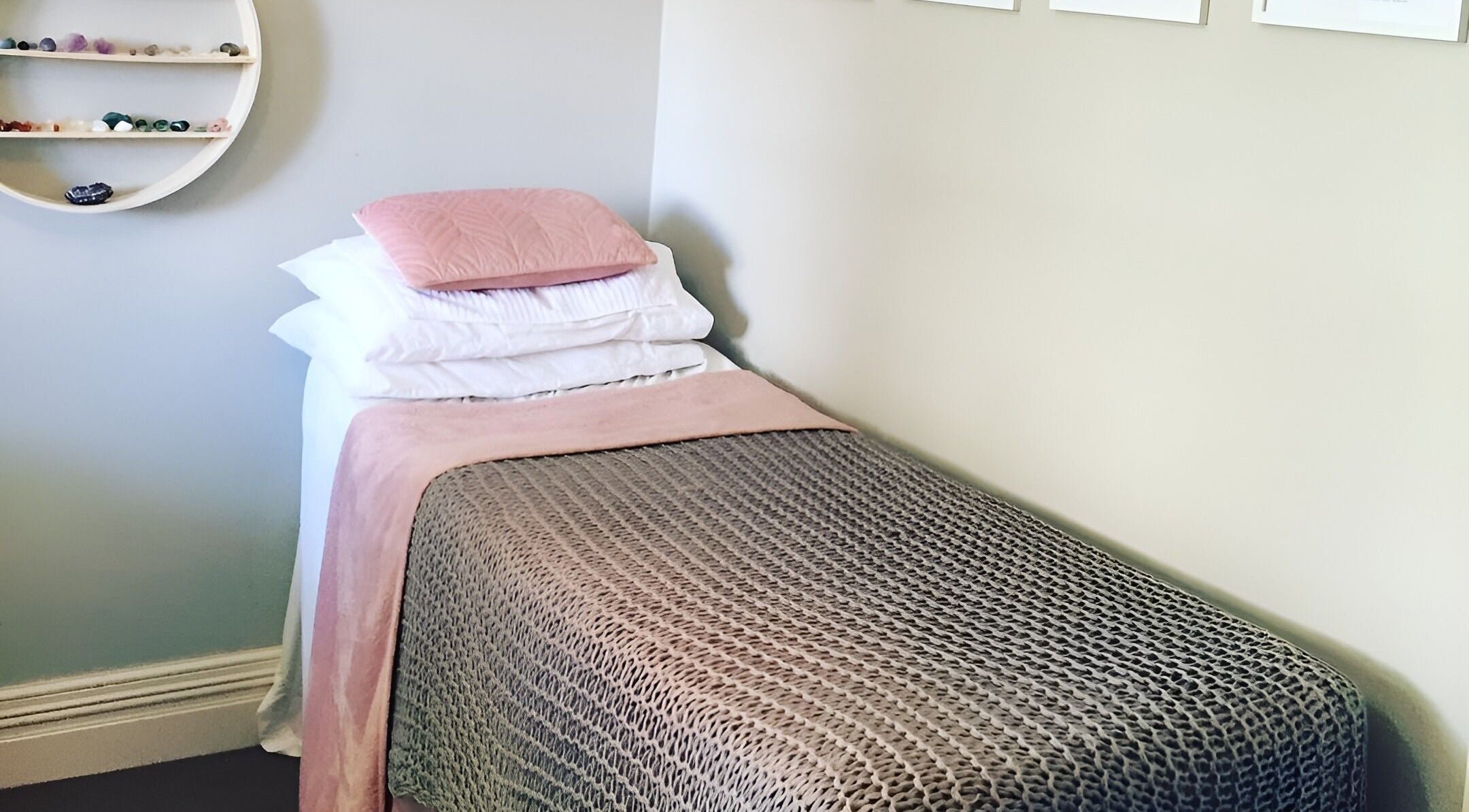 Relaxing treatment room at Kylie Paekau, Hamilton, Waikato, NZ featuring a cozy bed with soft pink accents.