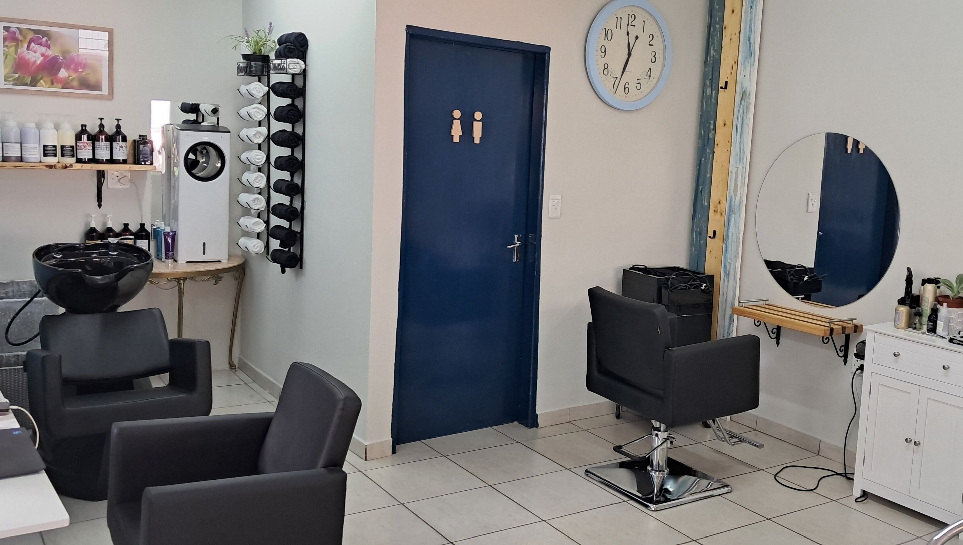 Stylish interior of Hairon116 salon in Roodepoort, Gauteng, ZA featuring modern chairs and sleek decor.