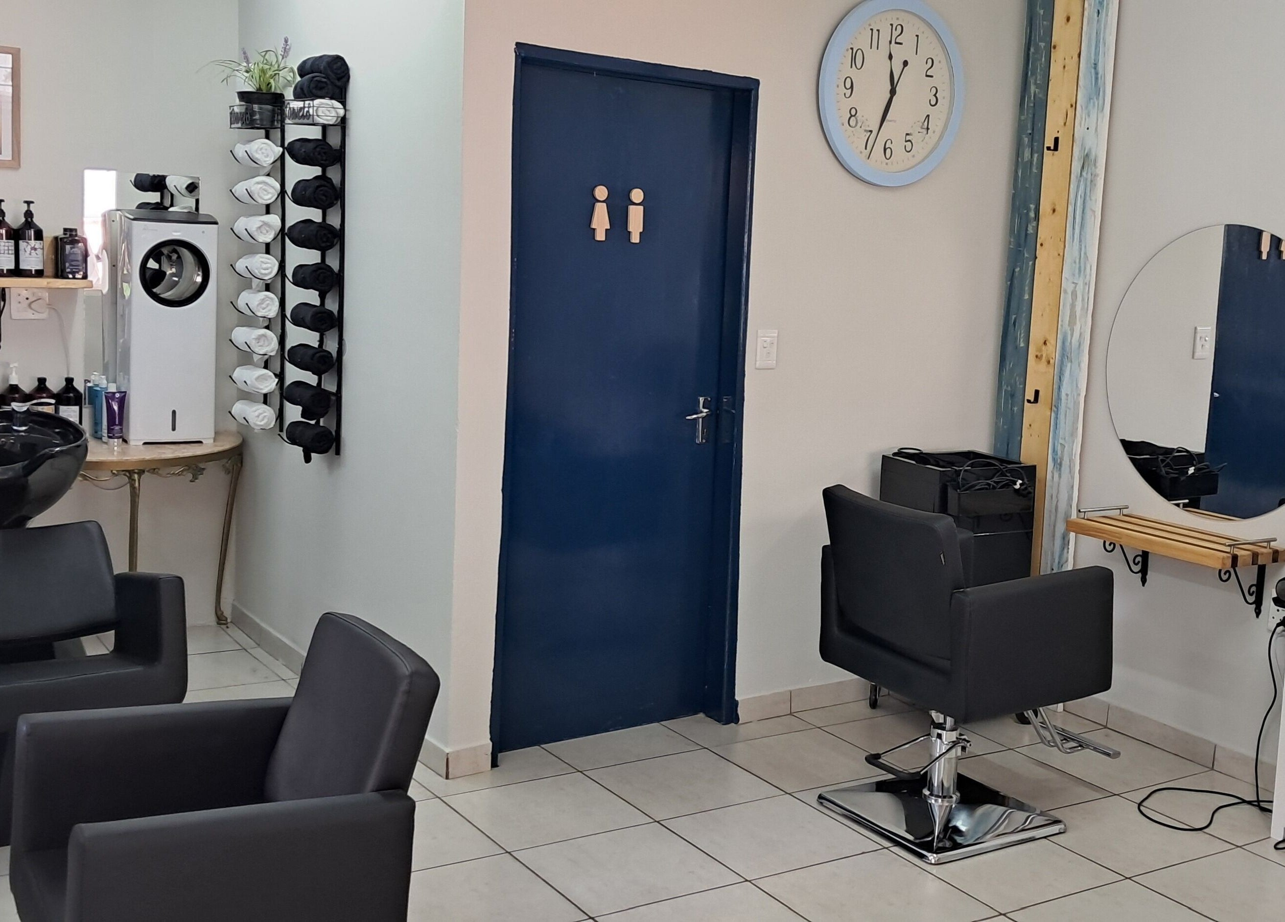 Stylish interior of Hairon116 salon in Roodepoort, Gauteng, ZA featuring modern chairs and sleek decor.