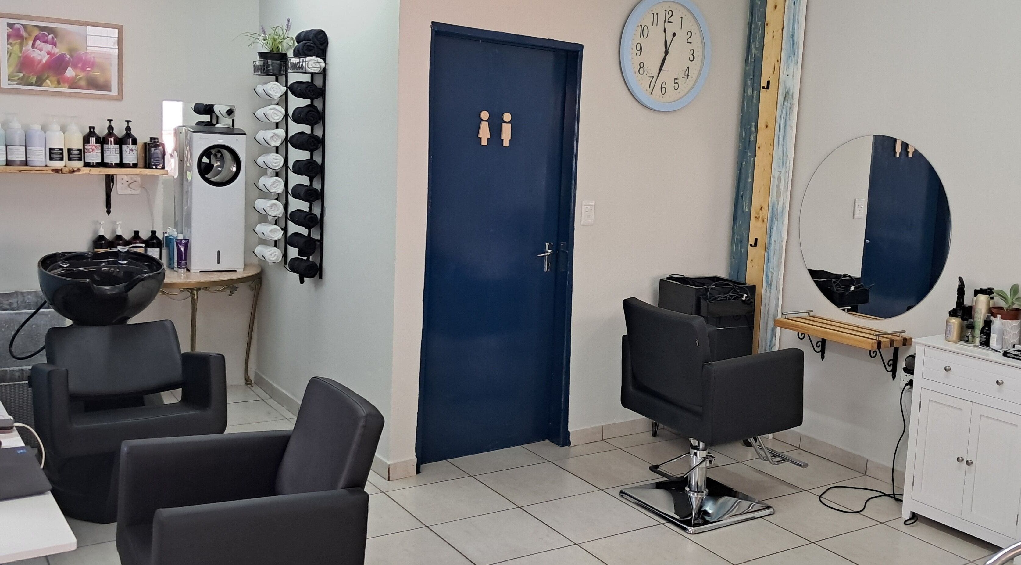 Stylish interior of Hairon116 salon in Roodepoort, Gauteng, ZA featuring modern chairs and sleek decor.