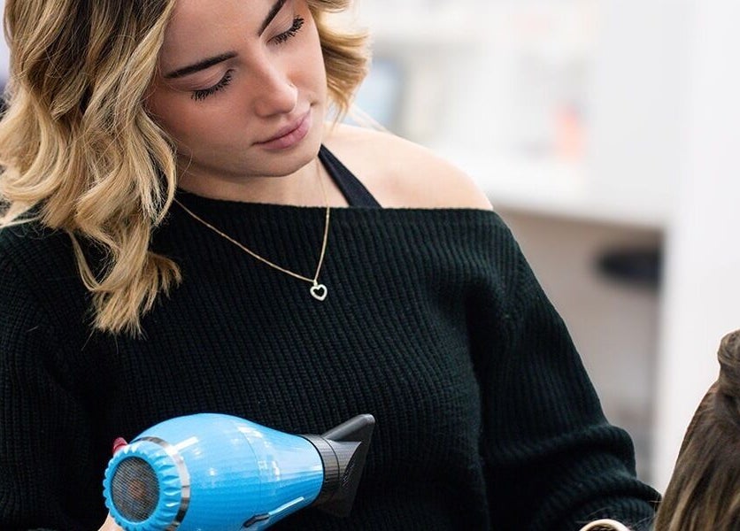 Stylist blow-drying hair at Argyle Hair Design in Picton, New South Wales, AU.
