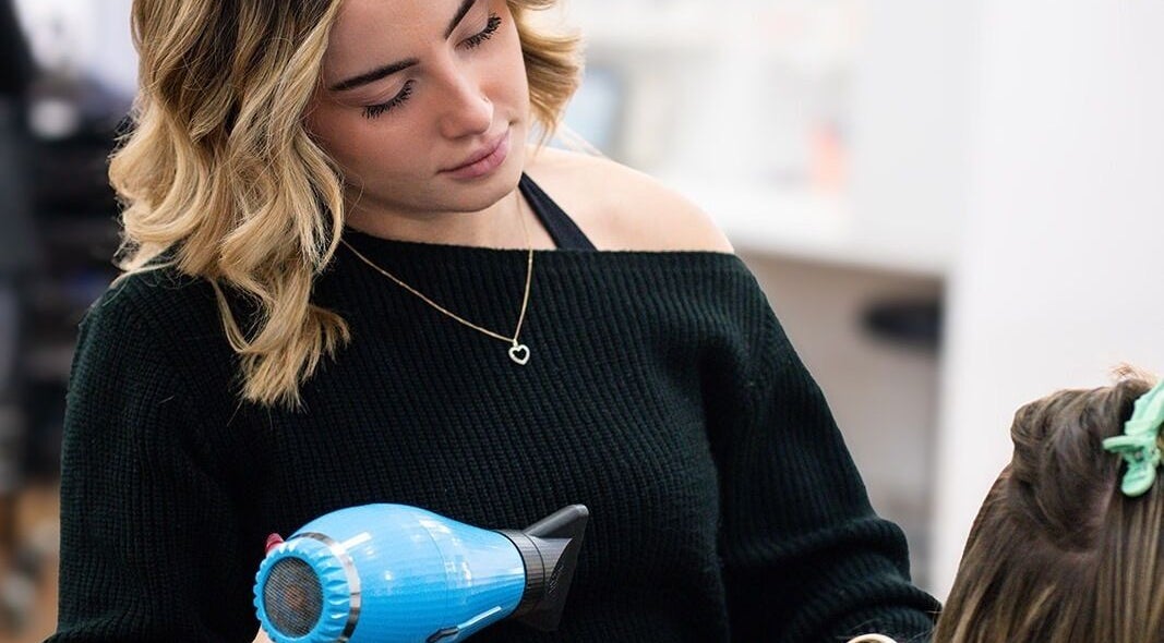 Stylist blow-drying hair at Argyle Hair Design in Picton, New South Wales, AU.
